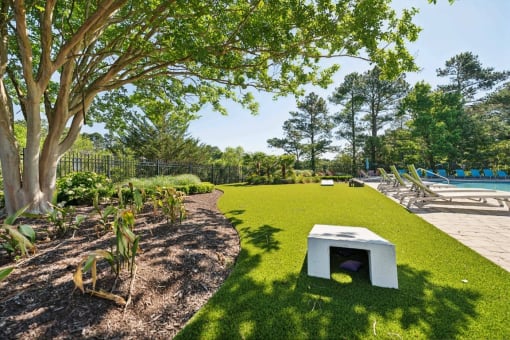 community pool with cornhole boards