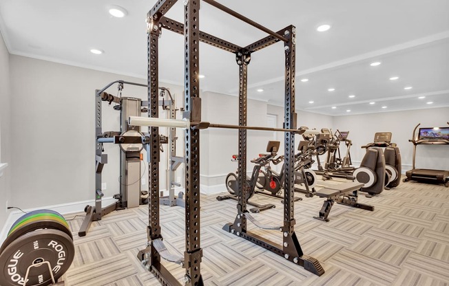a gym with weights and cardio equipment in a home with at Madison Brookhaven, Atlanta, GA