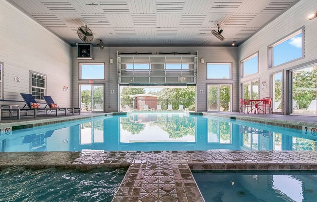 Indoor & Outdoor Pool Area With Garage Door That Goes Up