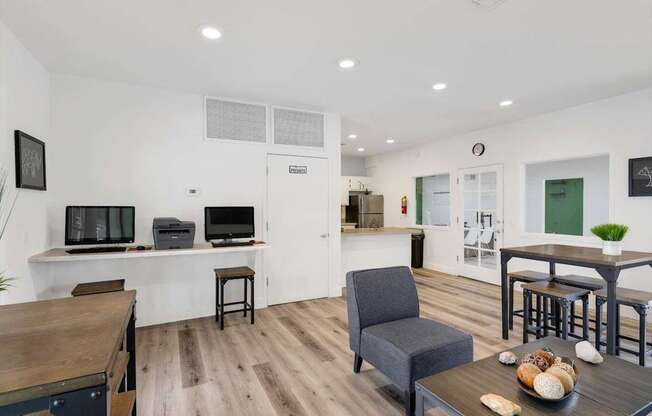 A living room with a grey armchair and a wooden table.