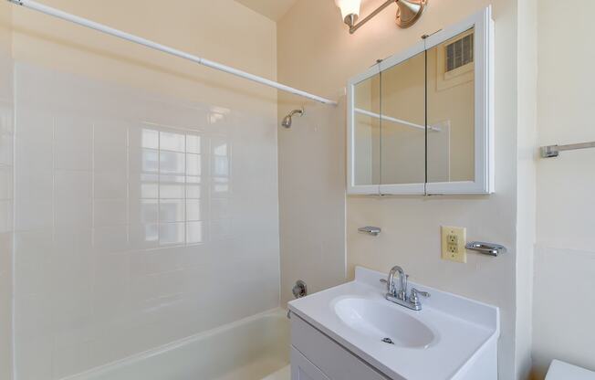 bathroom with toilet, vanity, tub, and medicine cabinet at twin oaks apartments columbia heights washington dc