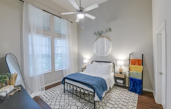 a bedroom with a bed and a ceiling fan