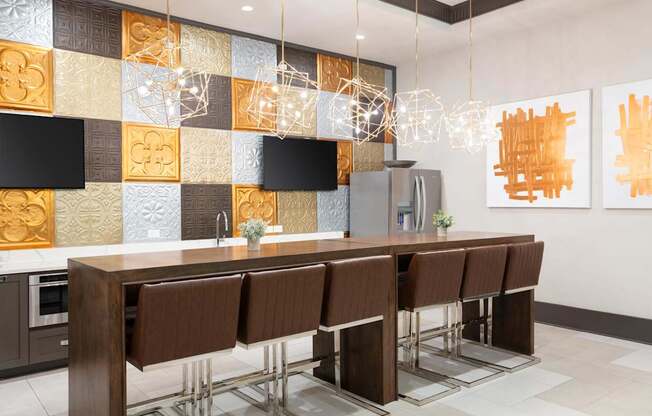 A modern kitchen with brown chairs and a wooden table.