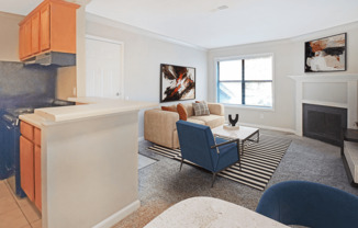 A living room with a blue chair and a fireplace.