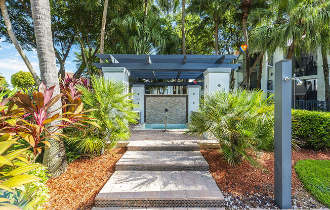 A pathway leads to a building with a sign that reads