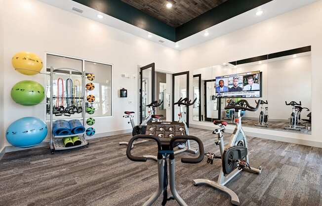 a home gym with exercise equipment and a flat screen tv