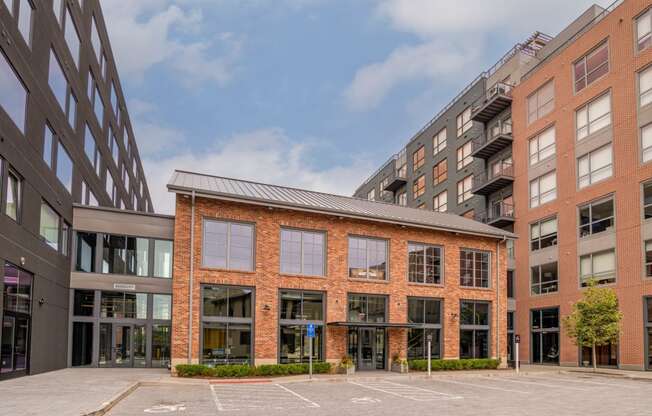 a large brick building with a courtyard in front of it