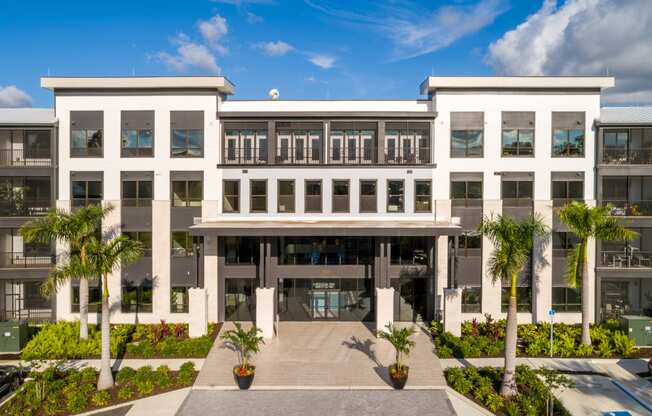 a large white building with a courtyard in front of it