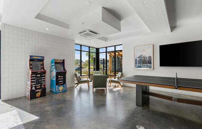 a living room with a pool table and a large window