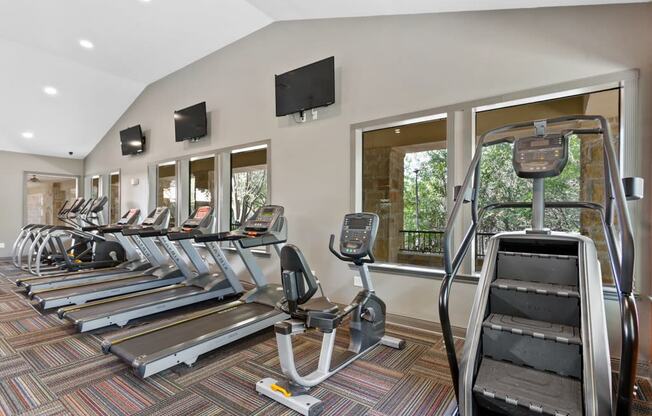 a row of cardio machines in a gym at The Verandah, Austin, 78726