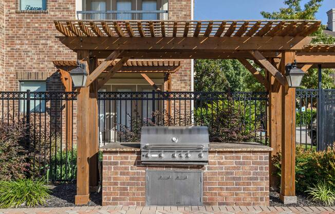 Gas grill area under pergola at Avenues at Craig Ranch apartments for rent in Dallas, TX