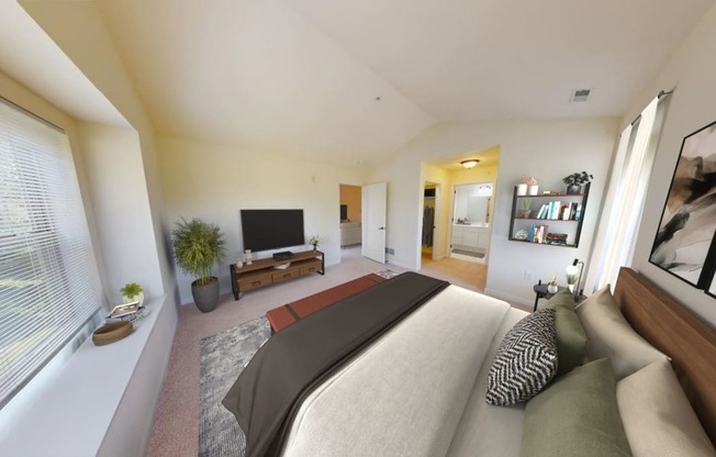 a bedroom with a large bed and a tv