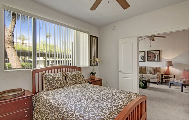 a bedroom with a bed and a ceiling fan