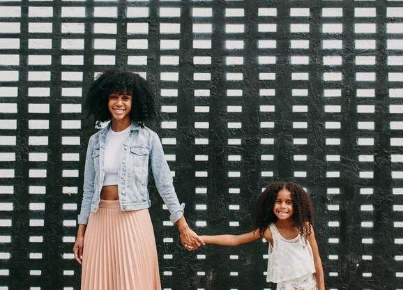 Woman and a child standing in front of a black and white wall  at Sono Central Residential, Norwalk, CT