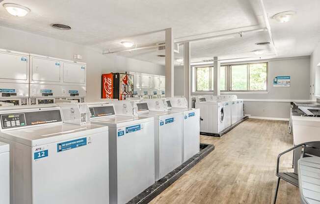 A laundromat with washers and dryers labeled E12