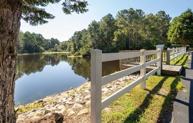 a view of a lake with a white fence
