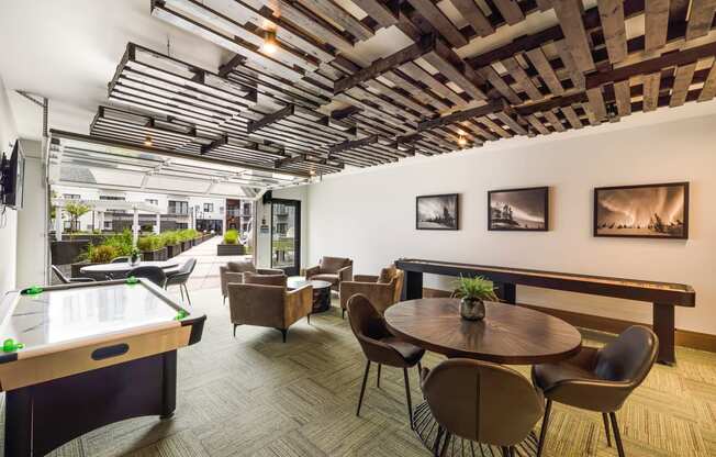 a room with tables and chairs and a pool table