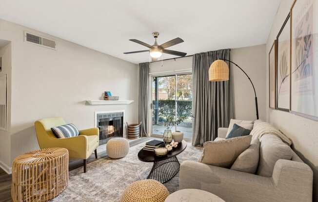 a living room with couches and chairs and a fireplace