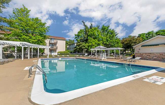 our resort style swimming pool is next to our building with trees