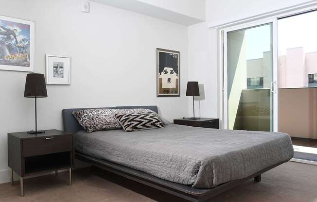A bedroom with a bed, nightstands, and a poster on the wall.