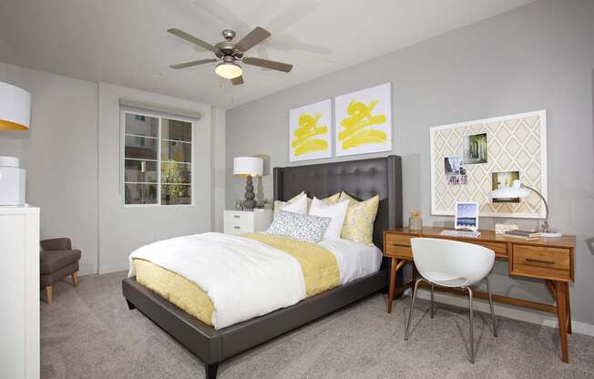 A bedroom with a bed, desk, and chair.