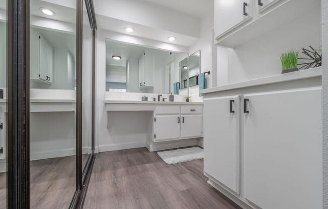 a bathroom with a sink and a mirror and a shower  at The Resort at Encinitas Luxury Apartment Homes, Encinitas, 92024