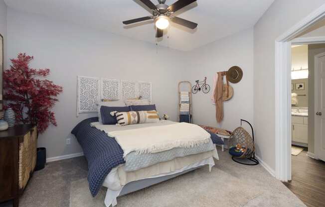 a bedroom with a bed and a ceiling fan