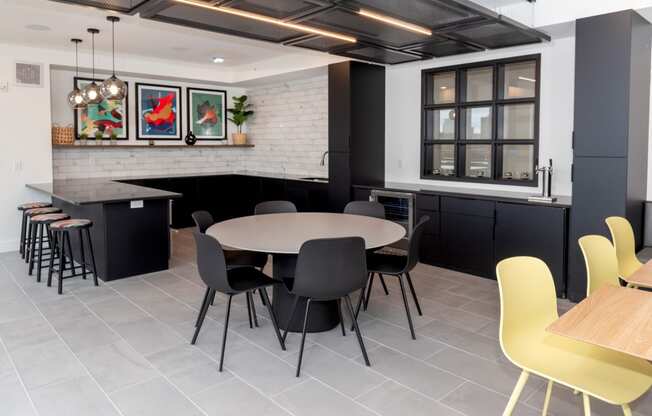 a dining room and kitchen with yellow chairs and a table