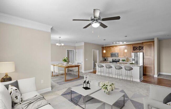a living room and kitchen with a ceiling fan