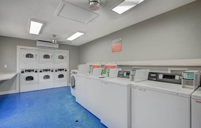 A laundry room with washers and dryers.