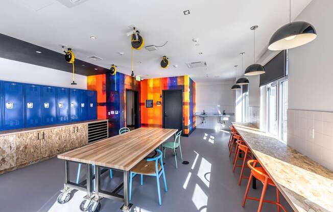 A room with a long table and chairs on wheels.