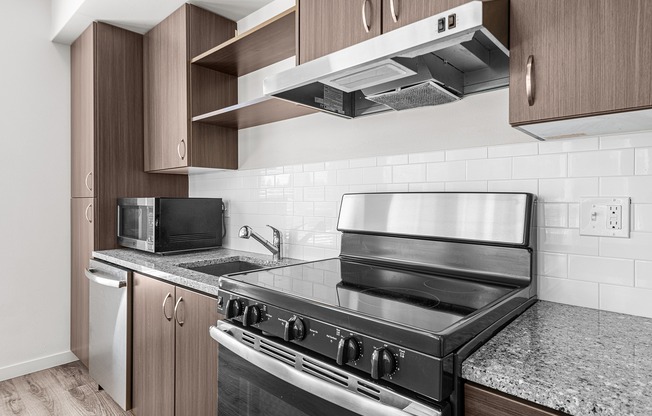 Large kitchen with stainless steel appliances, granite countertops and backsplash