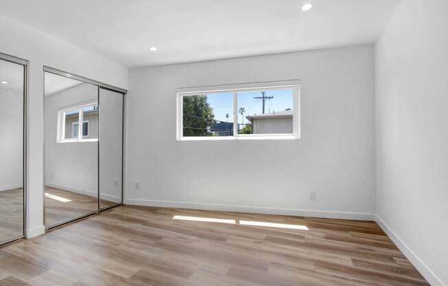 a living room with a large window and sliding glass doors