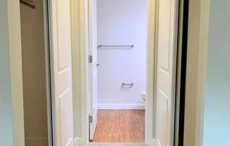 short hallway closet walkway and entrance to bathroom