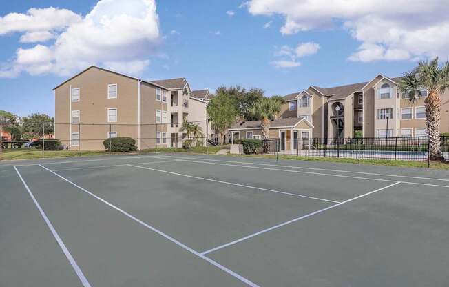 A parking lot in front of apartment buildings.