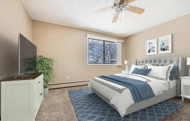 a bedroom with a large bed and a ceiling fan