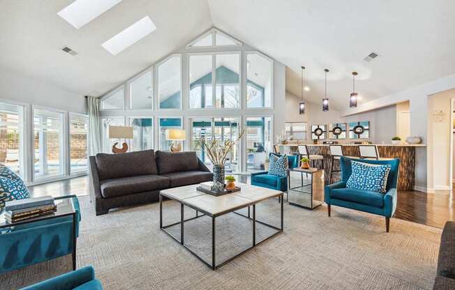 A living room with a glass wall and a skylight.