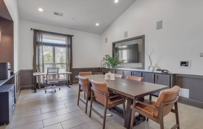 a dining room with a wooden table and chairs