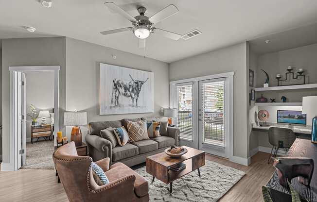 a living room with a couch and a ceiling fan