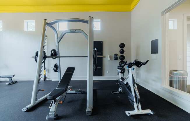 a gym with weights and cardio equipment in a hotel room