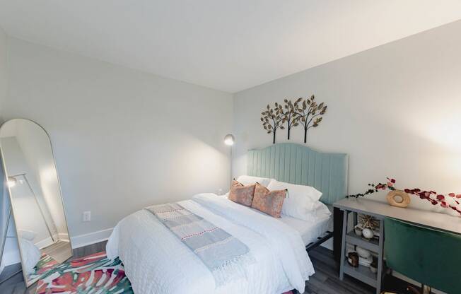 a bedroom with a white bed and a green headboard