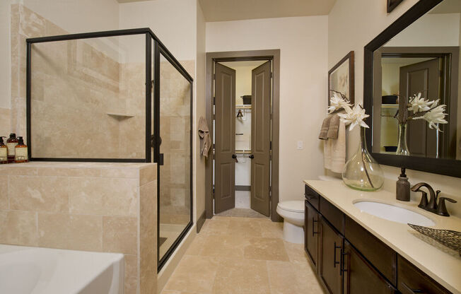 a bathroom with a sink and a shower and a toilet