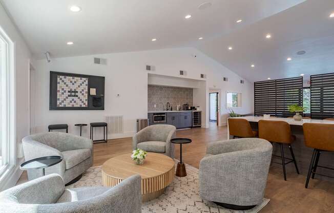 A living room with grey chairs and a wooden coffee table.