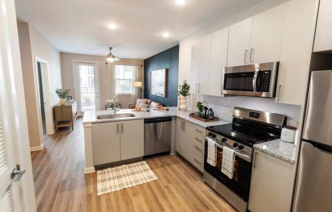 a kitchen with stainless steel appliances and white cabinets