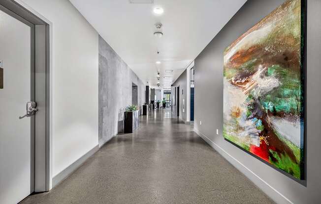A long hallway with a painting on the wall.