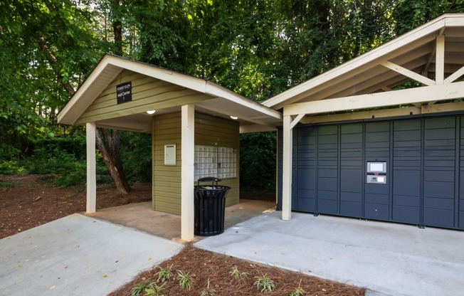 the garage has a concrete driveway and a garage door with a trash can