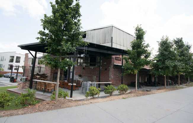 A building with a black roof and a sign that says "The Brewers" sits on a street corner.