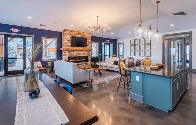 a large living room with a kitchen and a fireplace