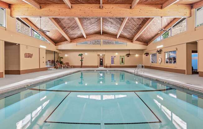 A large indoor swimming pool with a glass bottom.