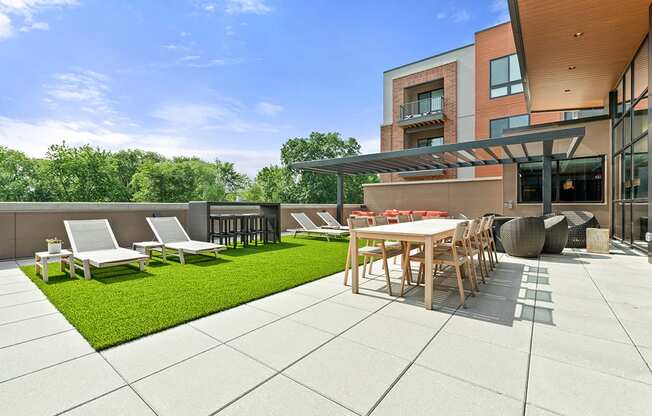 Roof-top terrace with grill, fire pits, and lounge area at Exton apartments Keva Flats